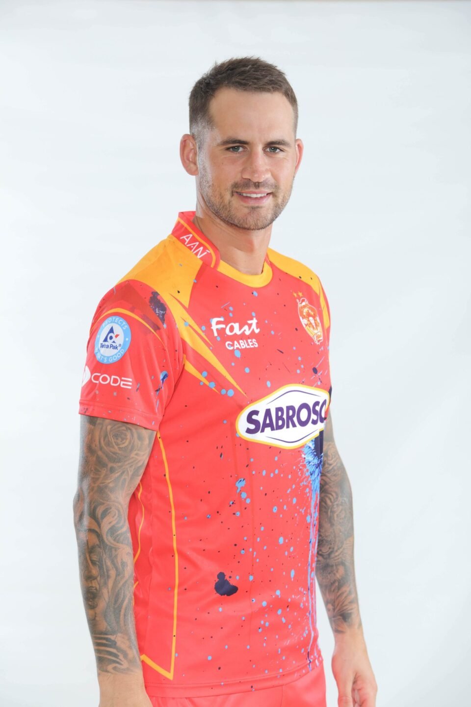Professional studio portrait of cricketer Alex Hales in the vibrant red and orange Islamabad United PSL jersey, captured by AHSANZ.