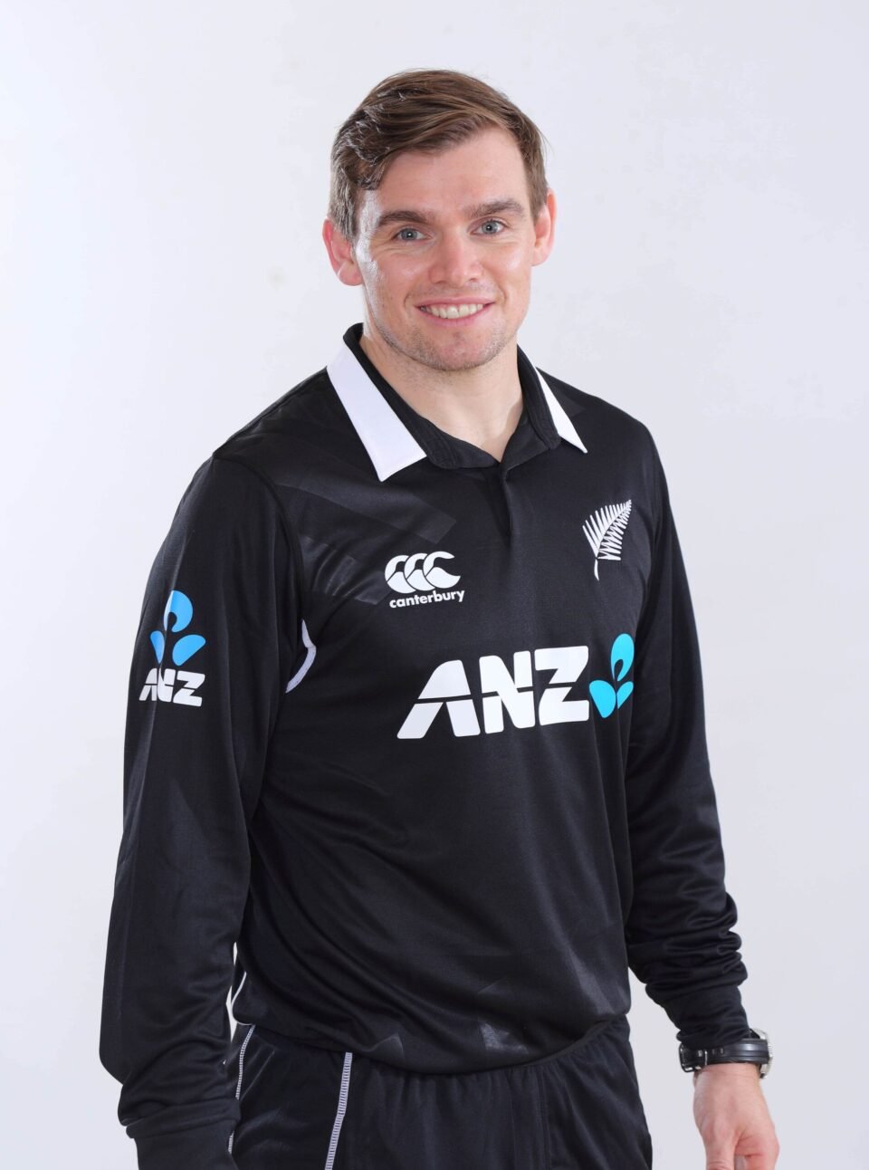 Professional studio portrait of New Zealand cricketer Tom Latham in the official black and white ANZ-sponsored national kit, by AHSANZ.